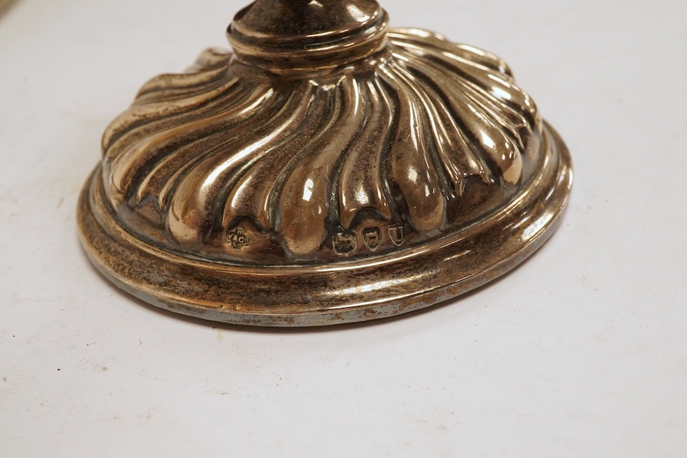 A George III silver helmet shaped cream jug, London, 1796, 14.7cm, together with two silver topped glass scent bottles, one Victorian, a pair of late Victorian silver dwarf candlesticks, London, 1895, a silver mounted ha